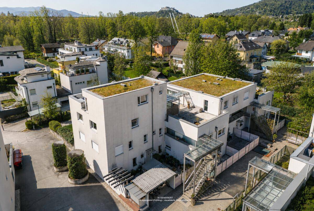 Luftaufnahme eines modernen Gebäudekomplexes mit begrünten Dächern in einer grünen Umgebung.