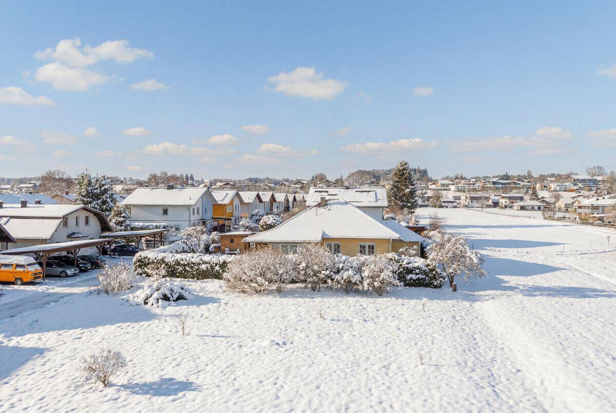 Winterlicher Panoramablick über eine verschneite Wohnsiedlung mit Einfamilienhäusern.