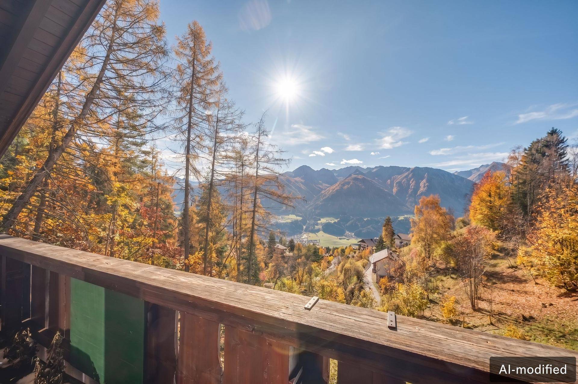 Sonniger Balkon mit weitem Panoramablick auf die umliegende Berglandschaft und das Tal.