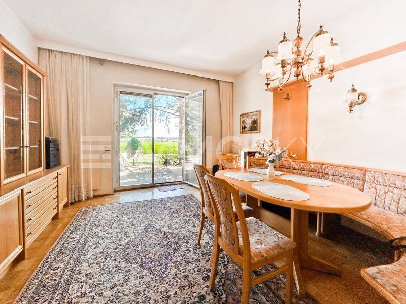 Gemütlicher Essbereich mit Holztisch, Eckbank und Zugang zur Terrasse oder Garten.
