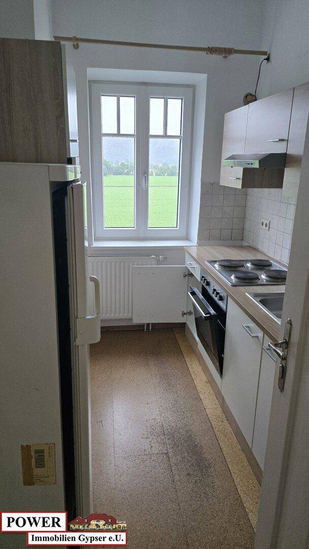 Kleine Küche mit Einbaugeräten, Fenster und Blick auf die umliegende Landschaft.