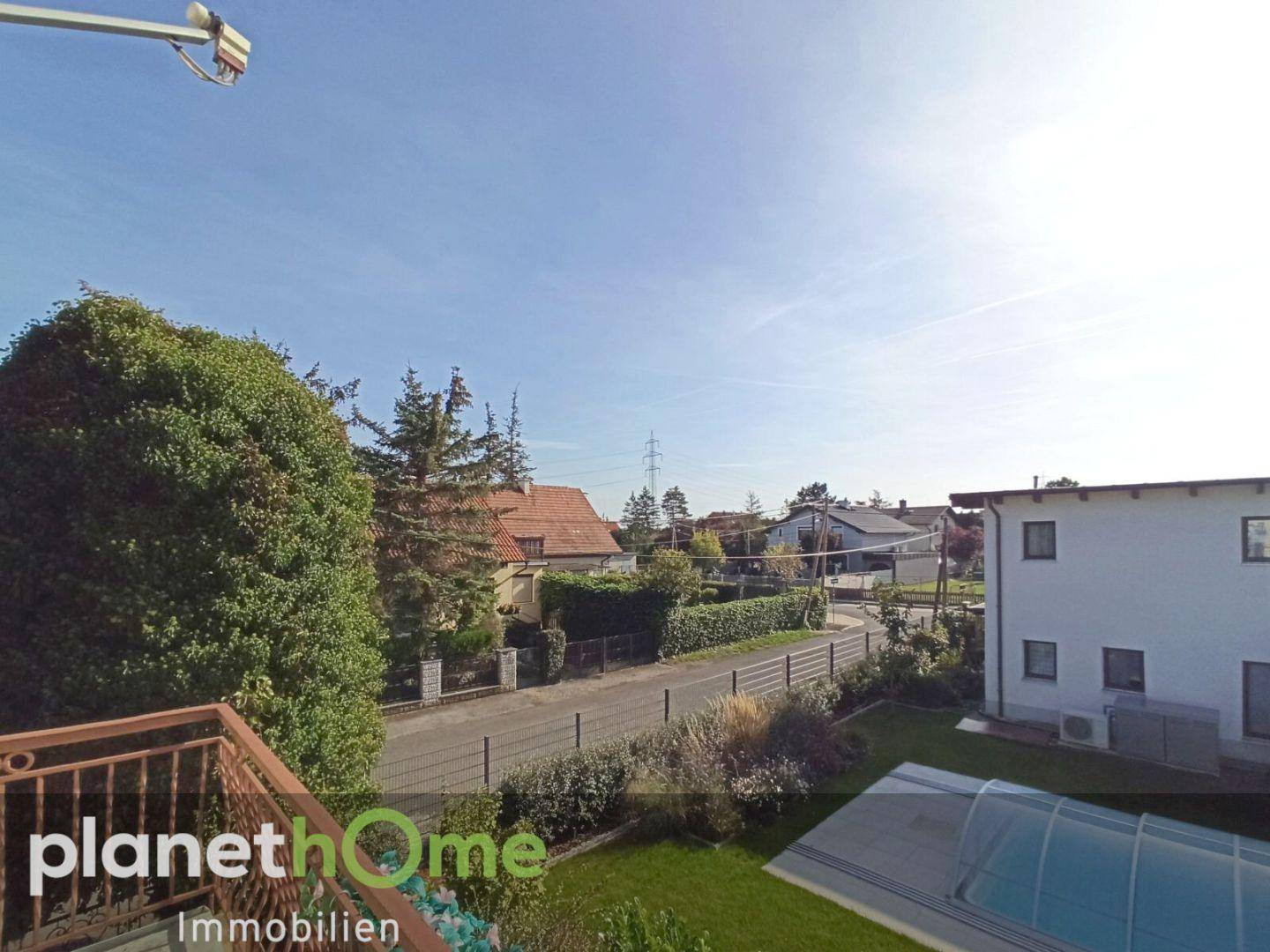 Ausblick vom Balkon auf die Nachbarschaft, Garten und den Poolbereich.