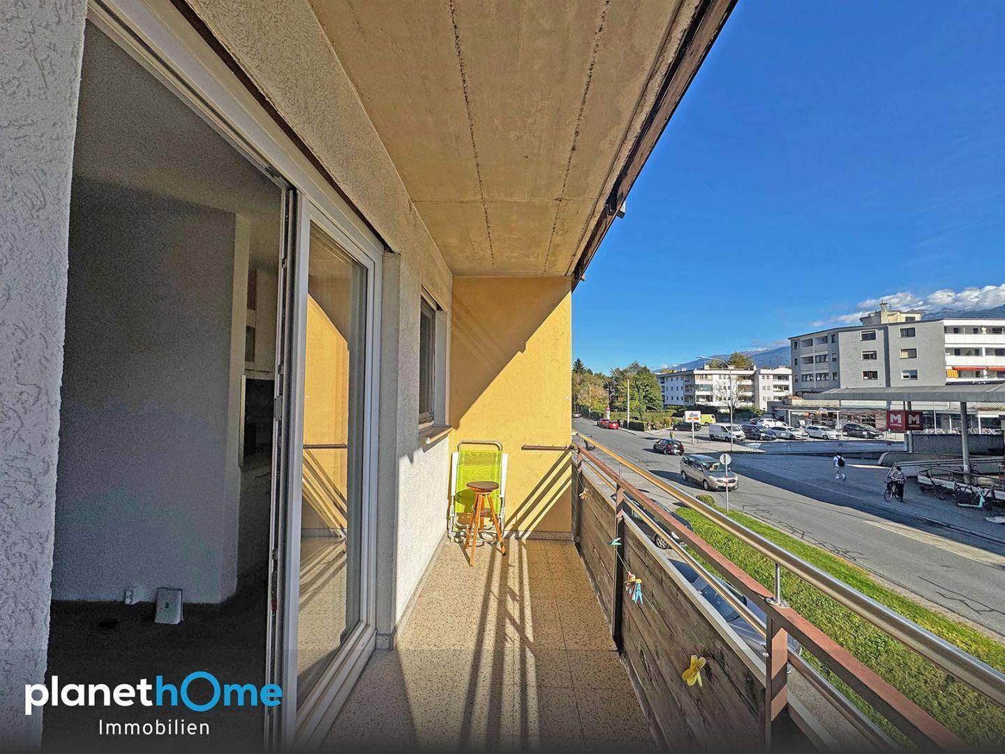 Balkon mit Blick auf die belebte Straße und die städtische Umgebung.