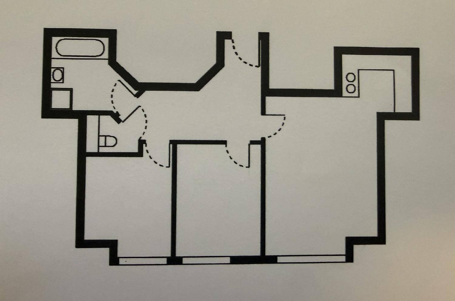 Grundriss einer Wohnung mit Bad, separatem WC, Küche und zwei weiteren Zimmern.