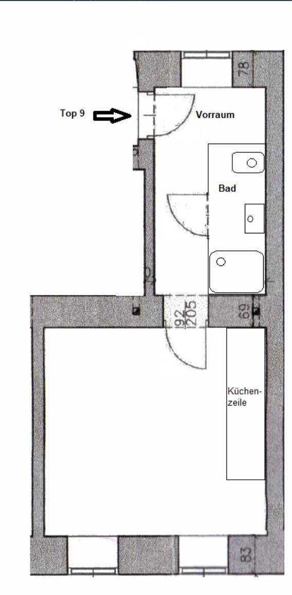 Grundriss einer kleinen Wohnung mit Vorraum, Bad und offenem Wohnbereich inklusive Küchenzeile.