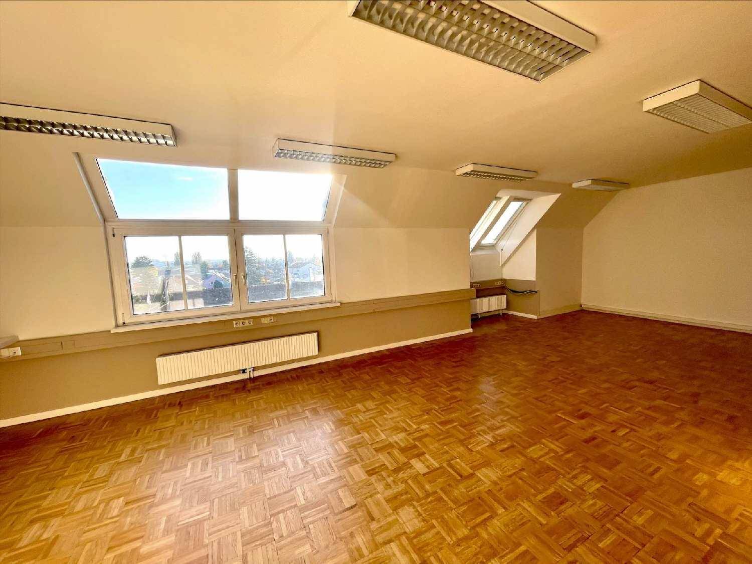 Geräumiger Büroraum im Dachgeschoss mit viel Tageslicht durch große Dachfenster, ideal für eine helle Arbeitsumgebung.