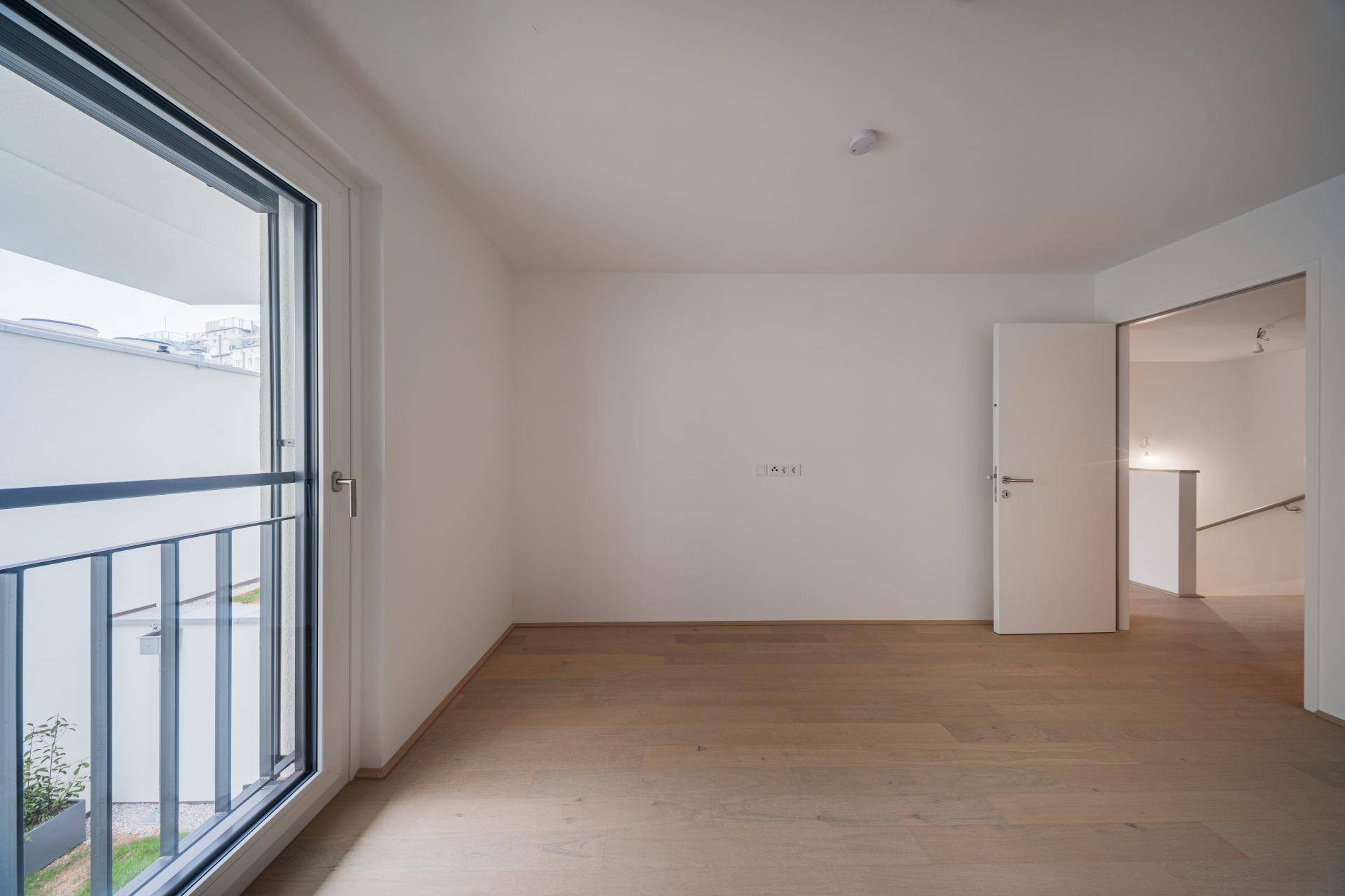 Helles Zimmer mit französischem Balkon und Zugang zum Flur, ideal als Schlaf- oder Arbeitszimmer.