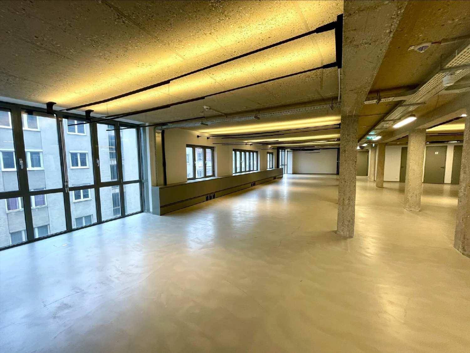 Großer, heller Büroraum mit bodentiefen Fenstern und Blick auf die Stadt.