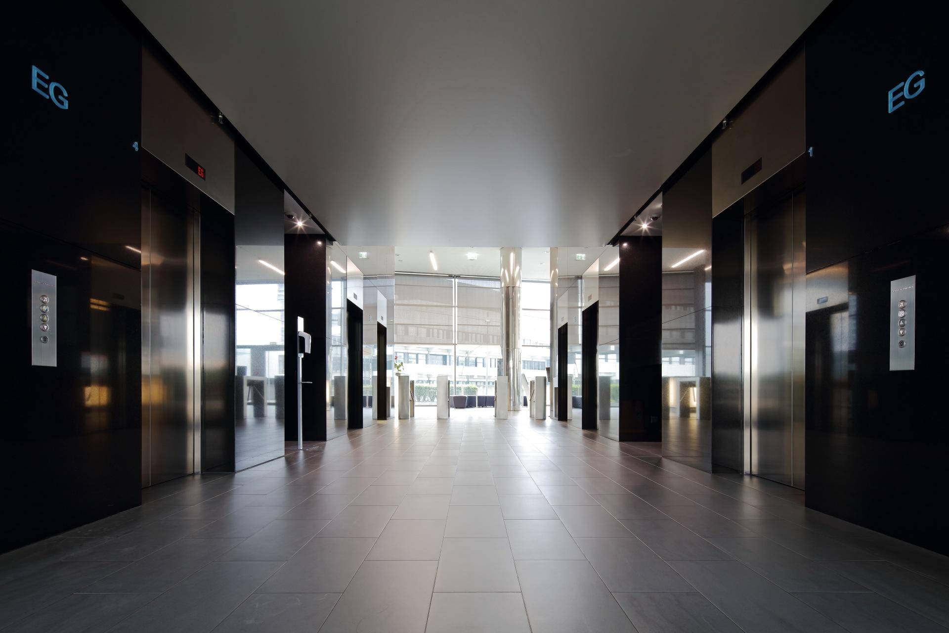 Elegante Lobby mit glänzenden Oberflächen, Aufzügen und modernem Design.
