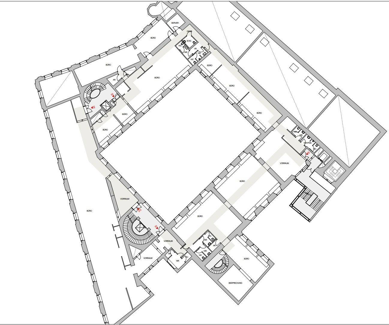 Detaillierter Grundriss eines großen Bürokomplexes mit mehreren Räumen und Treppenhäusern.