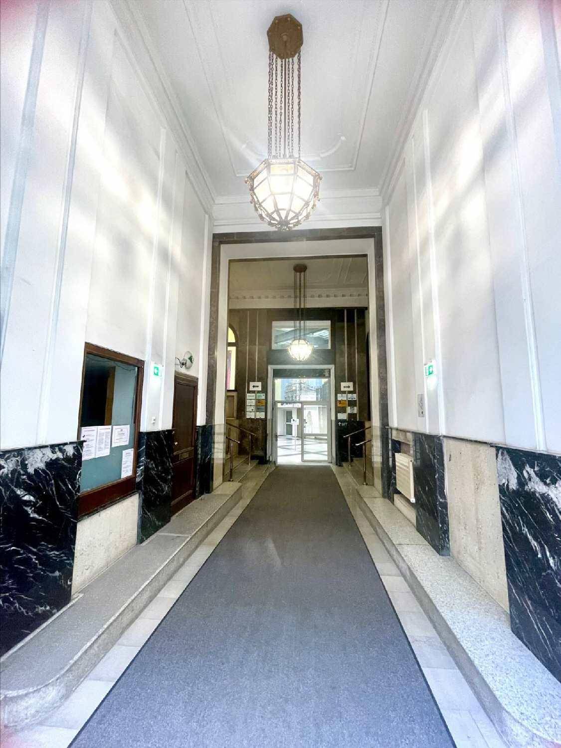 Prunkvoller Eingangsbereich mit hohen Decken, Marmorwänden und eleganten Kronleuchtern.