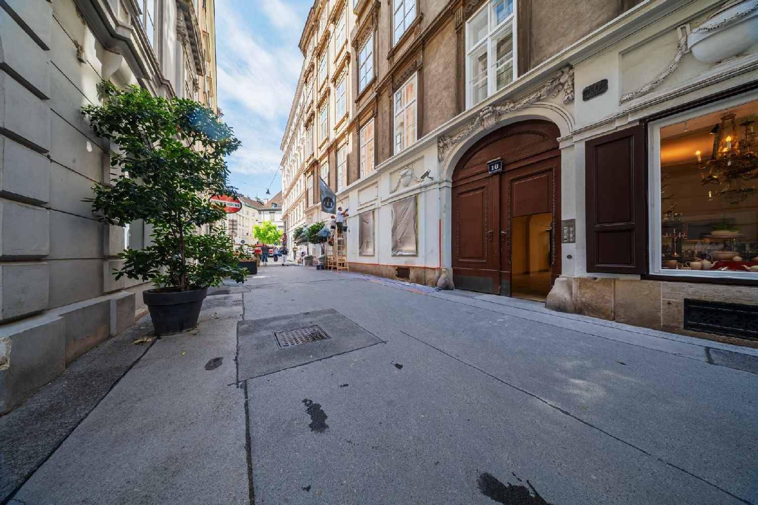 Historische Straßenansicht mit einem charmanten Altbau, großen Fenstern und einer Holztür.