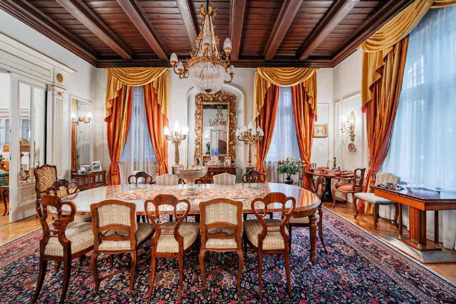 Prunkvolles Esszimmer mit Holzbalkendecke, großem Esstisch und schweren Vorhängen, ideal für festliche Anlässe.