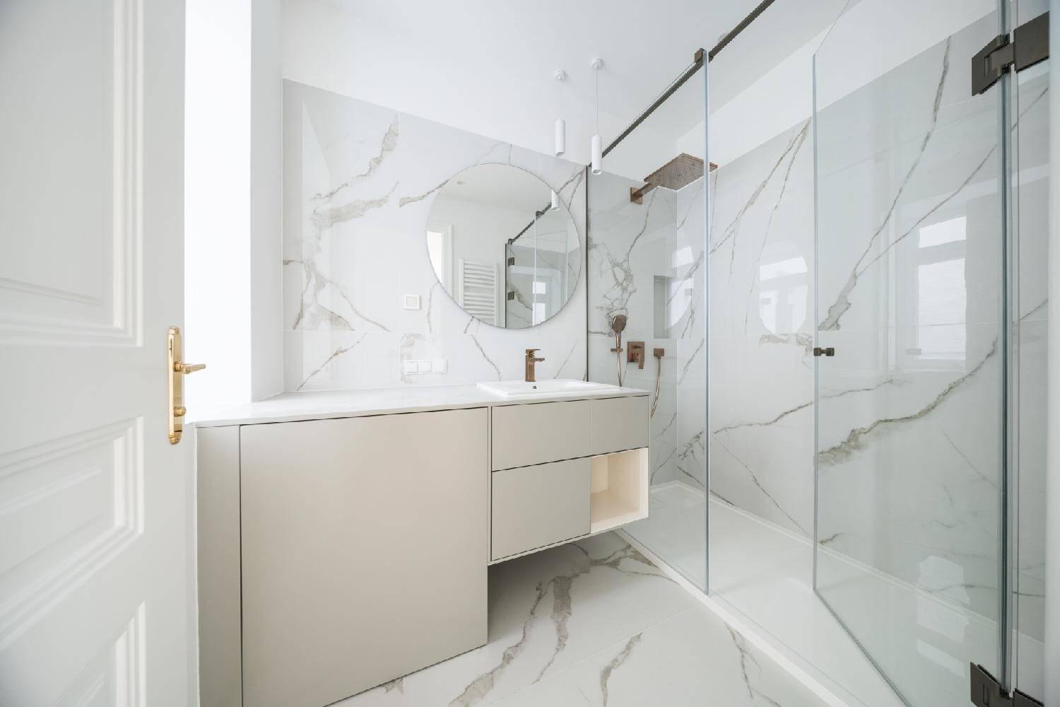 Modernes Badezimmer mit Marmoroptik-Fliesen, elegantem Waschtisch und geräumiger begehbarer Dusche.