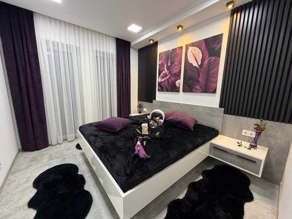 Stilvolles Schlafzimmer mit modernem Design, bequemen Möbeln und farblich abgestimmten Textilien.