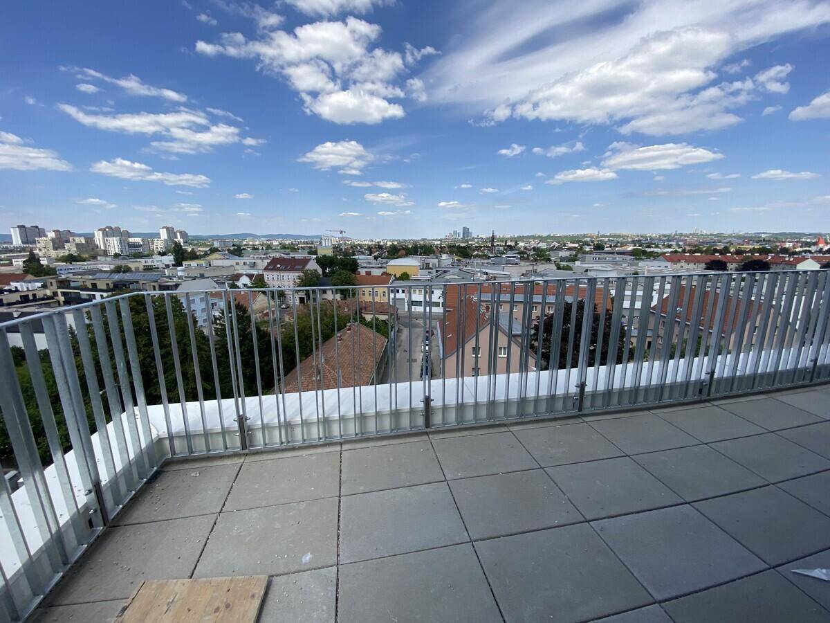 Weitläufige Terrasse mit Fliesenboden und Panoramablick über die Stadt und die Umgebung.