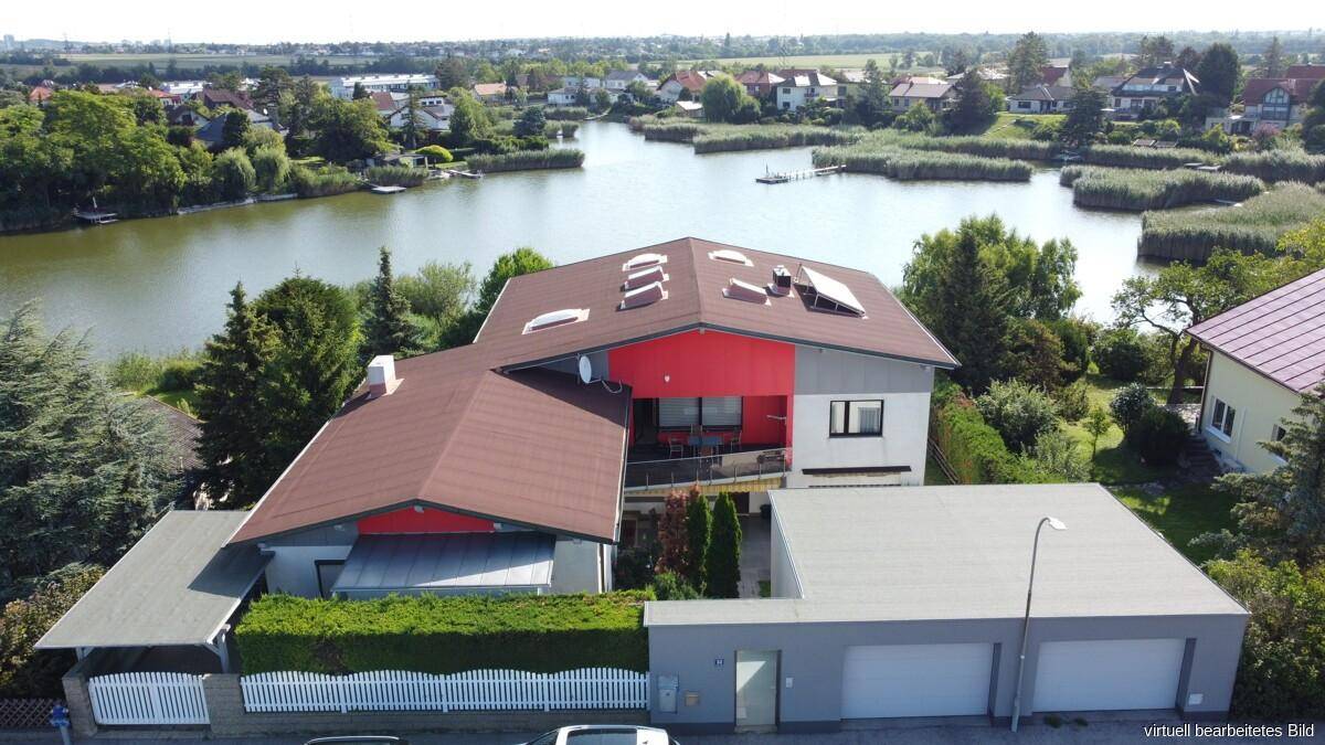 Übersicht des Anwesens von oben mit Wohnhaus, Garagen und direktem Zugang zum See.