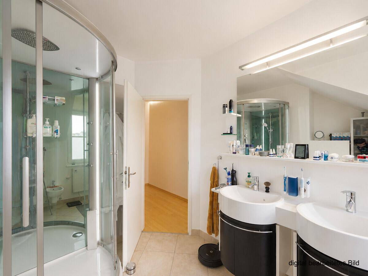 Helles Badezimmer mit runder Duschkabine, Doppelwaschbecken und Spiegelschrank.