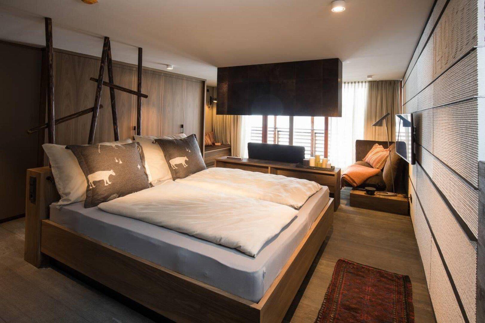 Geräumiges Schlafzimmer mit großem Bett, Holzakzenten und modernem Design.