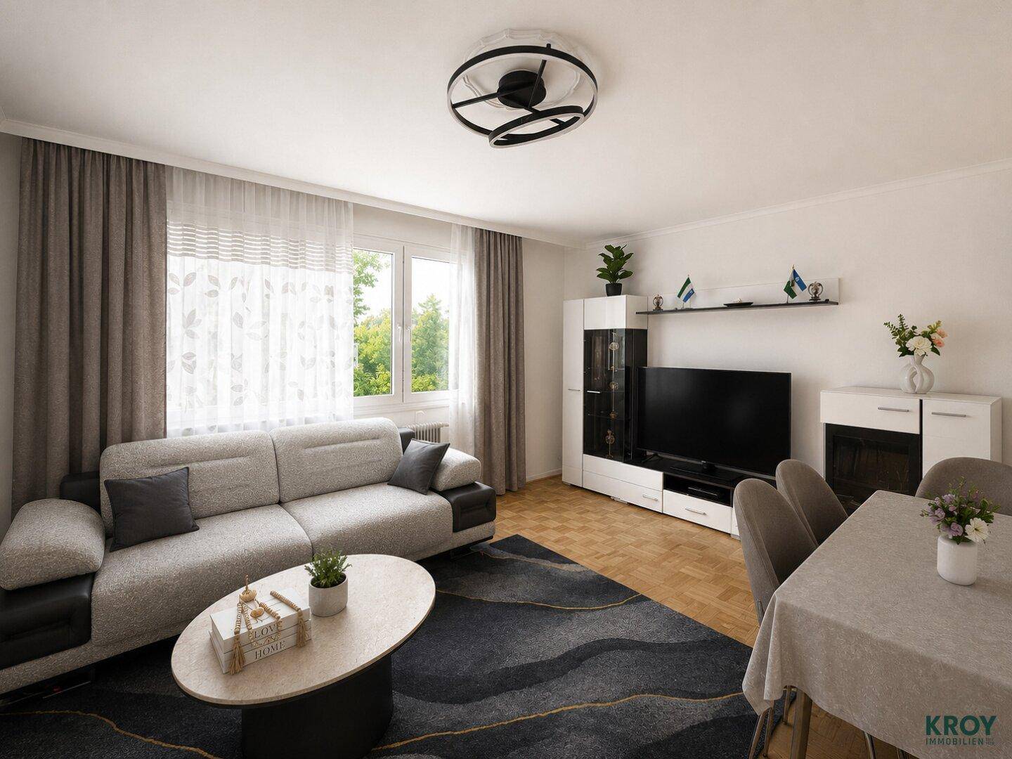 Heller Wohn- und Essbereich mit modernem Sofa, Esstisch und Blick ins Grüne.