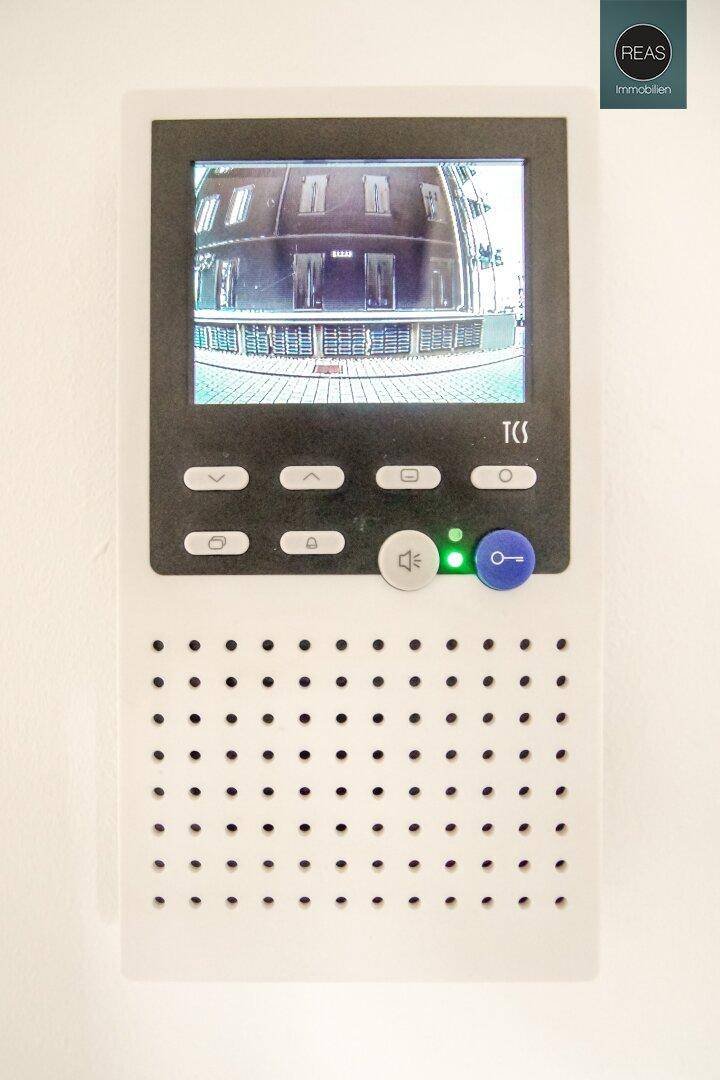 Eine moderne Video-Gegensprechanlage ist an der Wand im Eingangsbereich montiert.