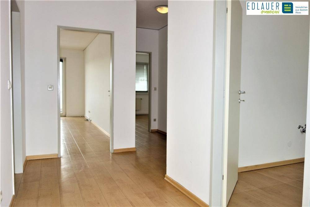 Heller Flur mit Parkettboden, der zu verschiedenen Zimmern der Wohnung führt.