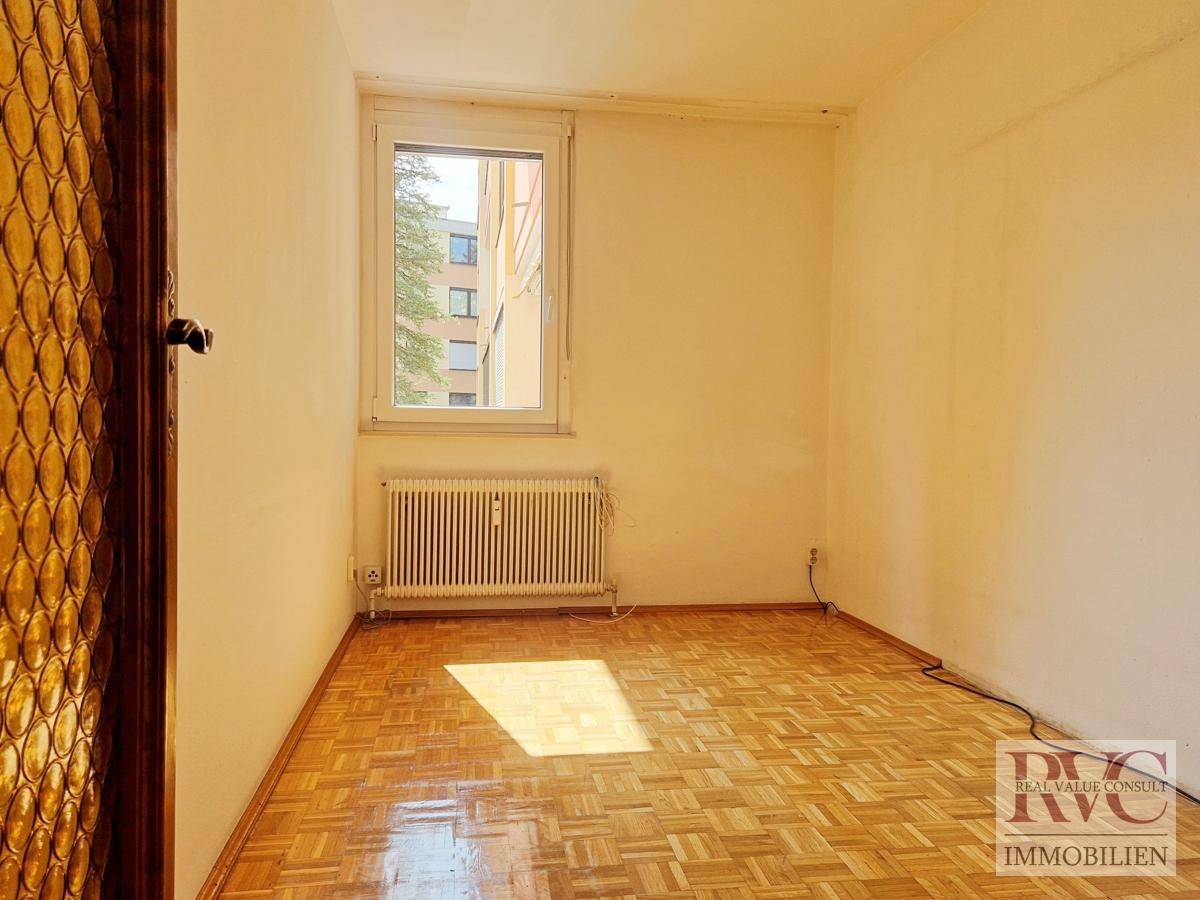 Kleineres Zimmer mit Parkettboden und Fenster, ideal als Kinder- oder Arbeitszimmer.