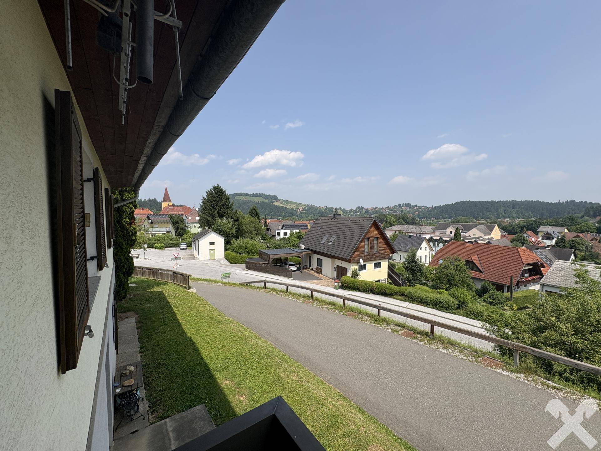 Panoramablick von der Immobilie auf die umliegende Wohnsiedlung und die bewaldeten Hügel.