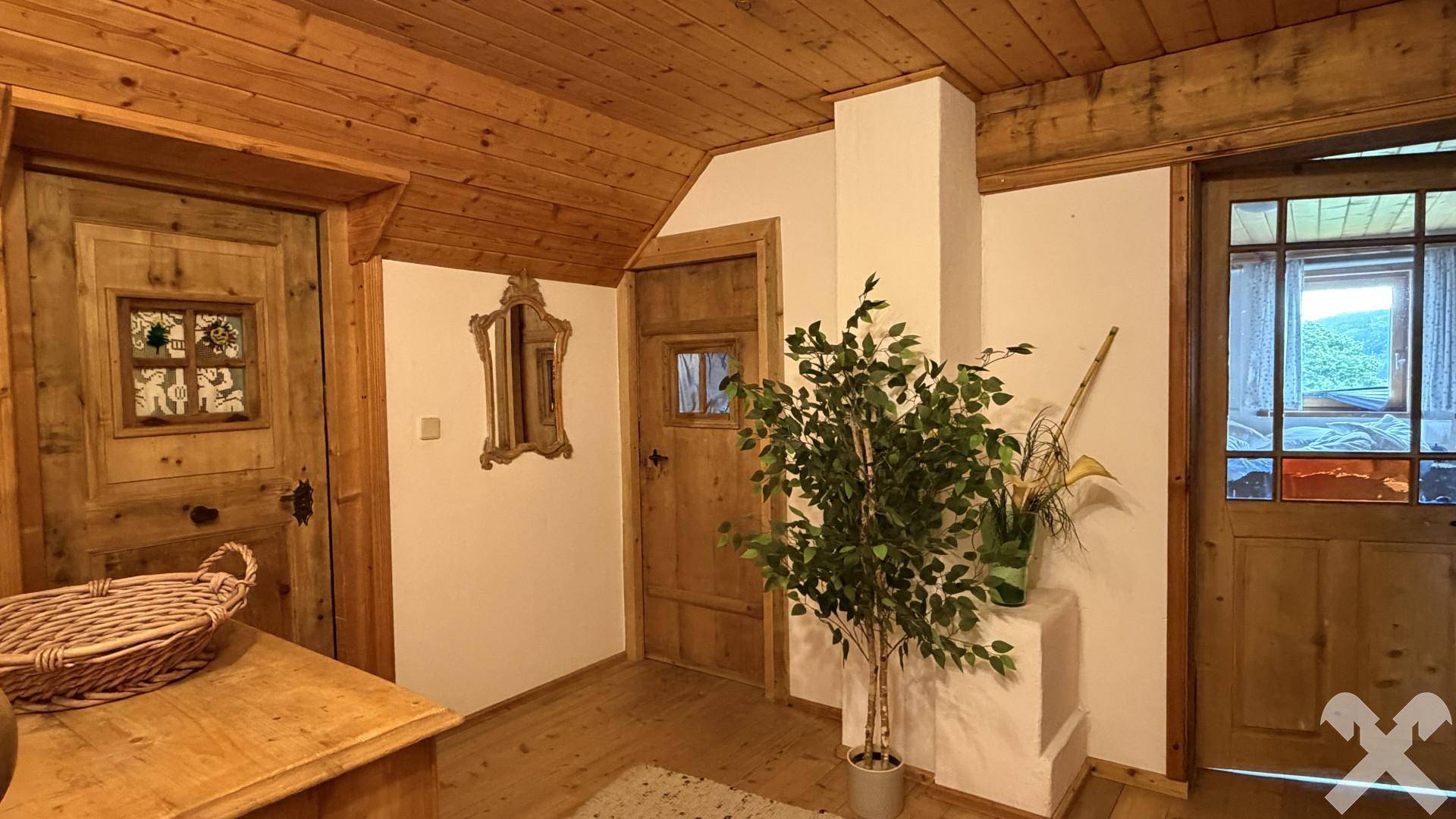 Gemütlicher Flur mit Holztüren, Holzdecke und einem dekorativen Spiegel im traditionellen Stil.