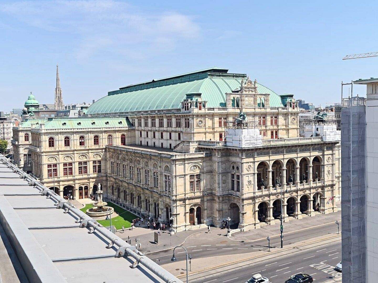 Panoramablick auf ein historisches Gebäude mit grünem Dach und die umliegende Stadtlandschaft.