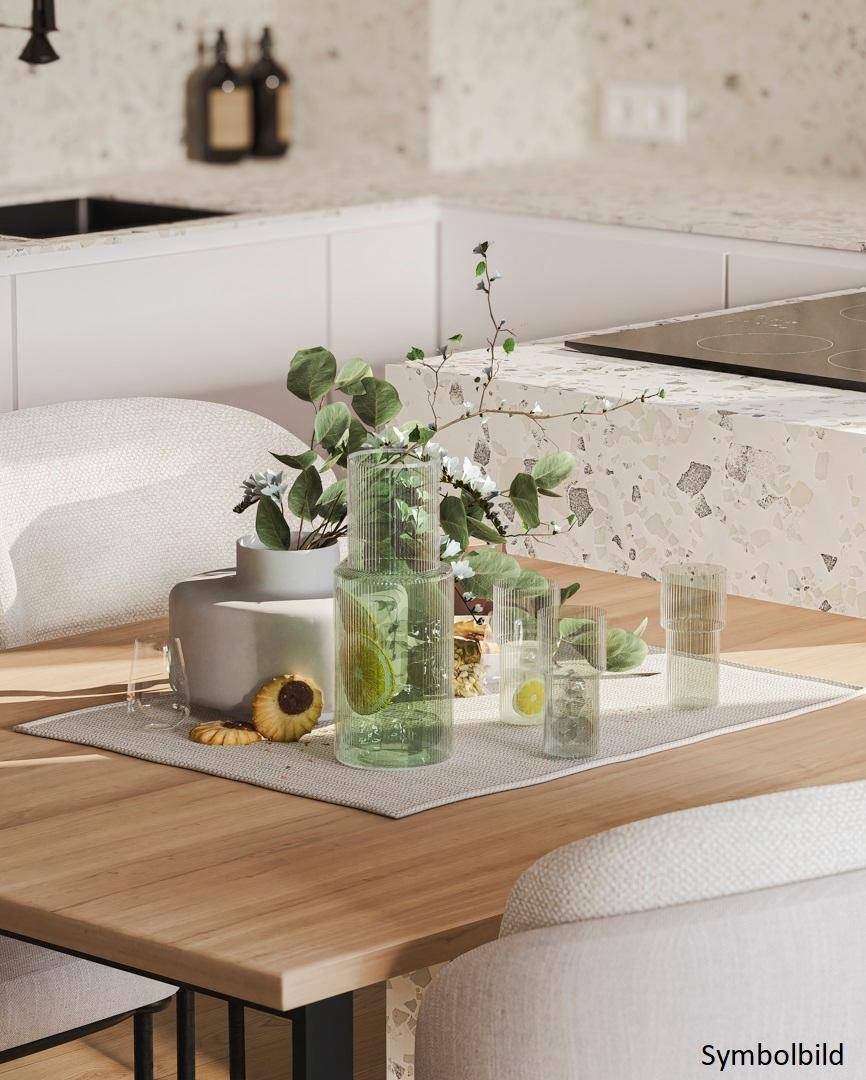 Detailansicht der modernen Küchenarbeitsplatte mit Terrazzo-Optik und stilvoller Dekoration.