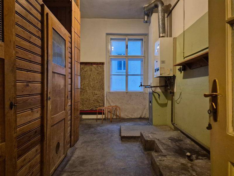 Hauswirtschaftsraum mit Gastherme, Fenster und Holzschränken, ideal für praktische Zwecke.