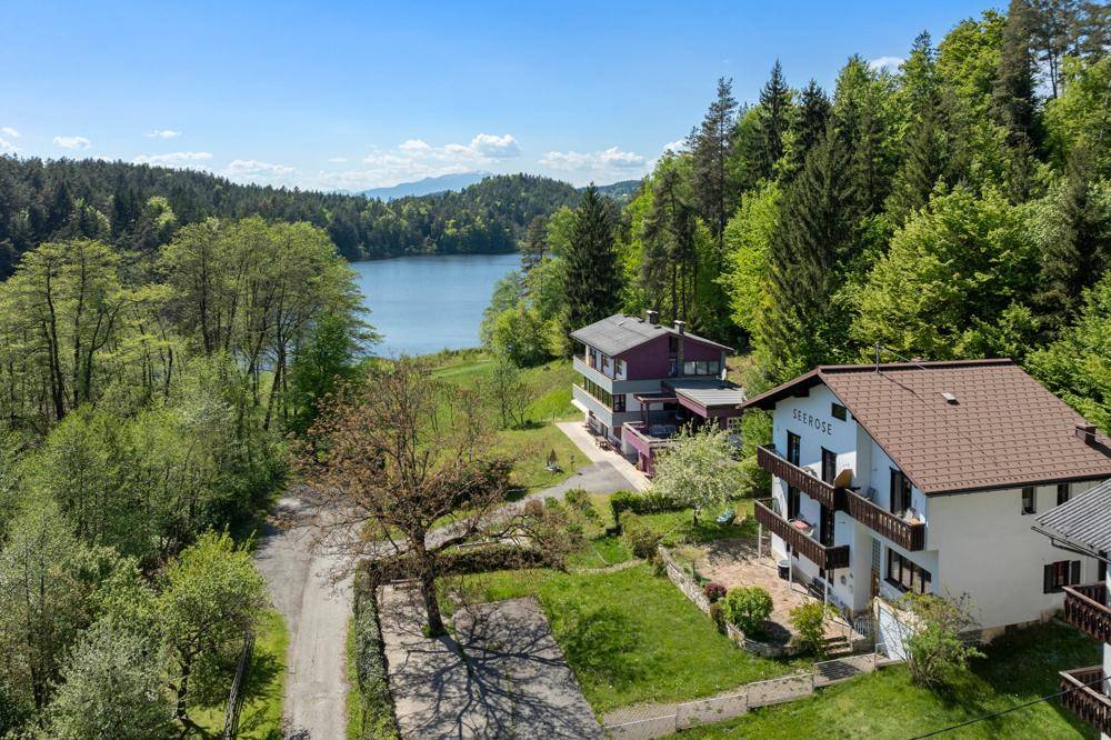 Luftaufnahme des Hauses "SEEROSE" und eines Nachbargebäudes mit See- und Waldblick.