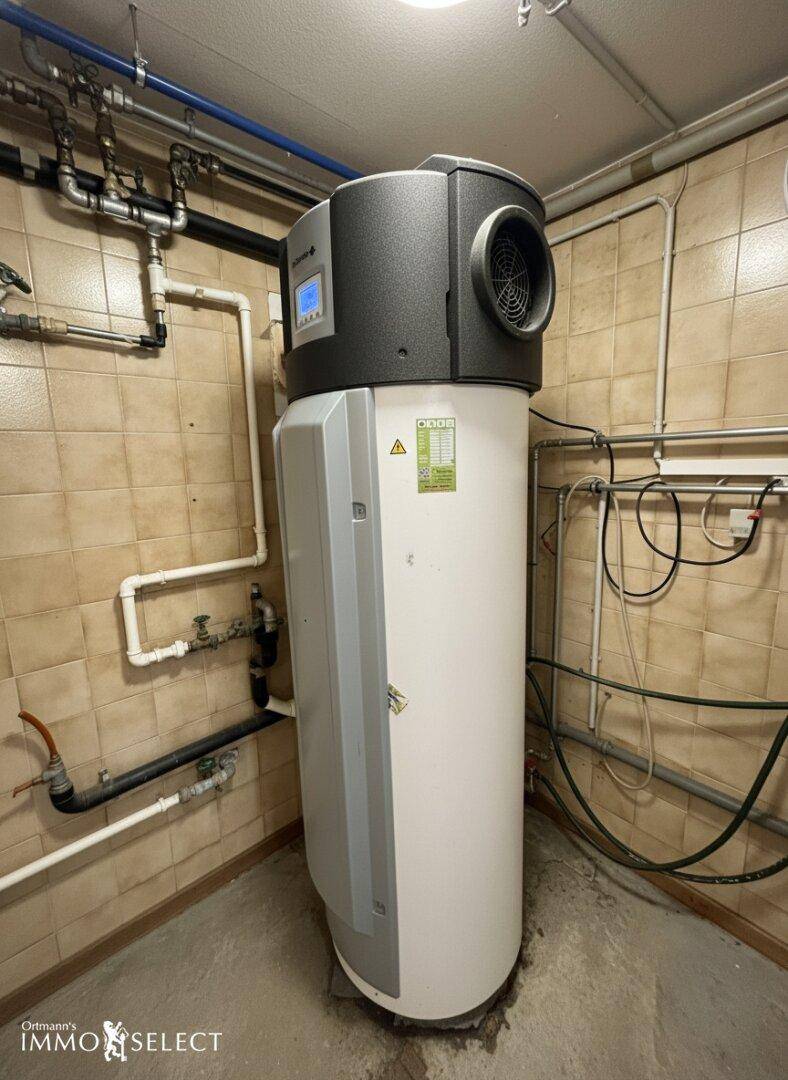 Warmwasserspeicher und Heizungsanlage in einem gefliesten Raum, bereit für den Betrieb.
