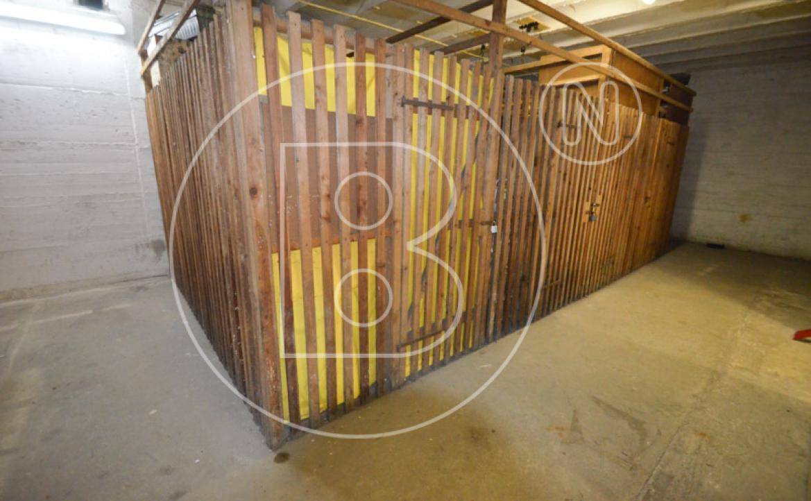 Abstellräume im Keller mit Holzwänden und Betonboden, ideal für zusätzlichen Stauraum.