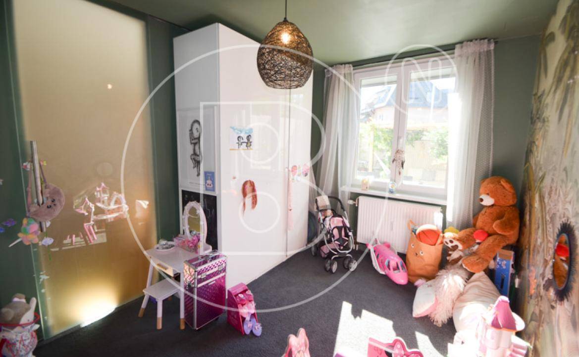 Helles Kinderzimmer mit Fenster, Heizung und viel Platz zum Spielen.