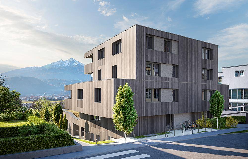 Moderne Architektur des Gebäudes mit Holzfassade und Blick auf die umliegende Berglandschaft.