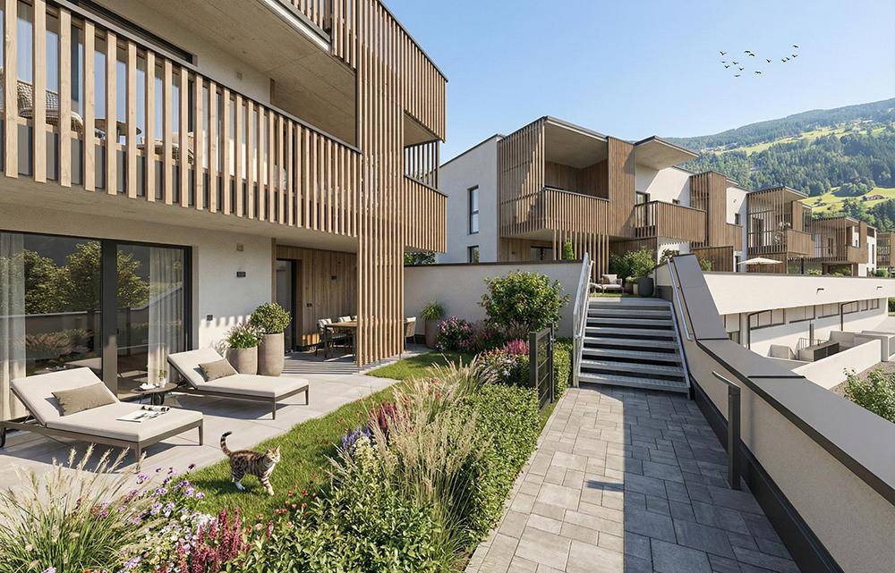 Gepflegter Gartenbereich mit Liegestühlen und Zugang zu den oberen Wohneinheiten.