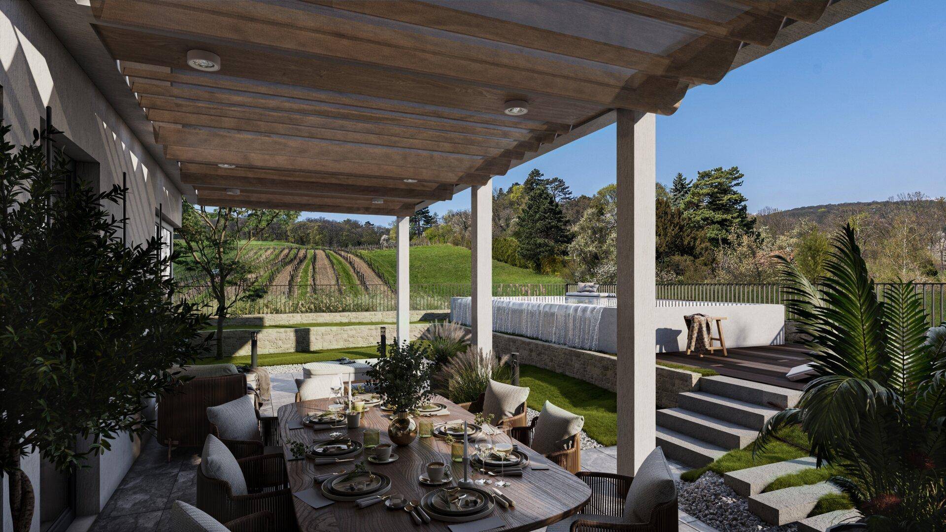 Überdachte Terrasse mit großem Esstisch, Lounge-Möbeln und Blick auf die Weinberge.