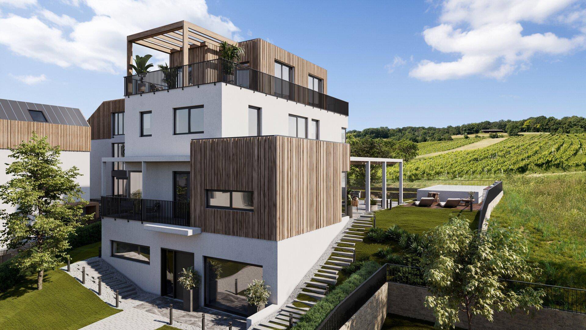 Modernes Gebäude mit Holzfassade, Terrassen und einer grünen Rasenfläche, umgeben von Weinbergen.