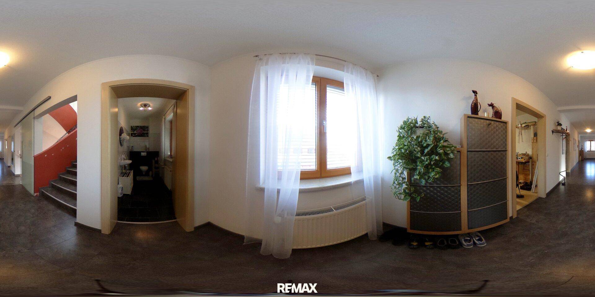 Eingangsbereich mit Fenster, Garderobe und Zugang zu verschiedenen Räumen.