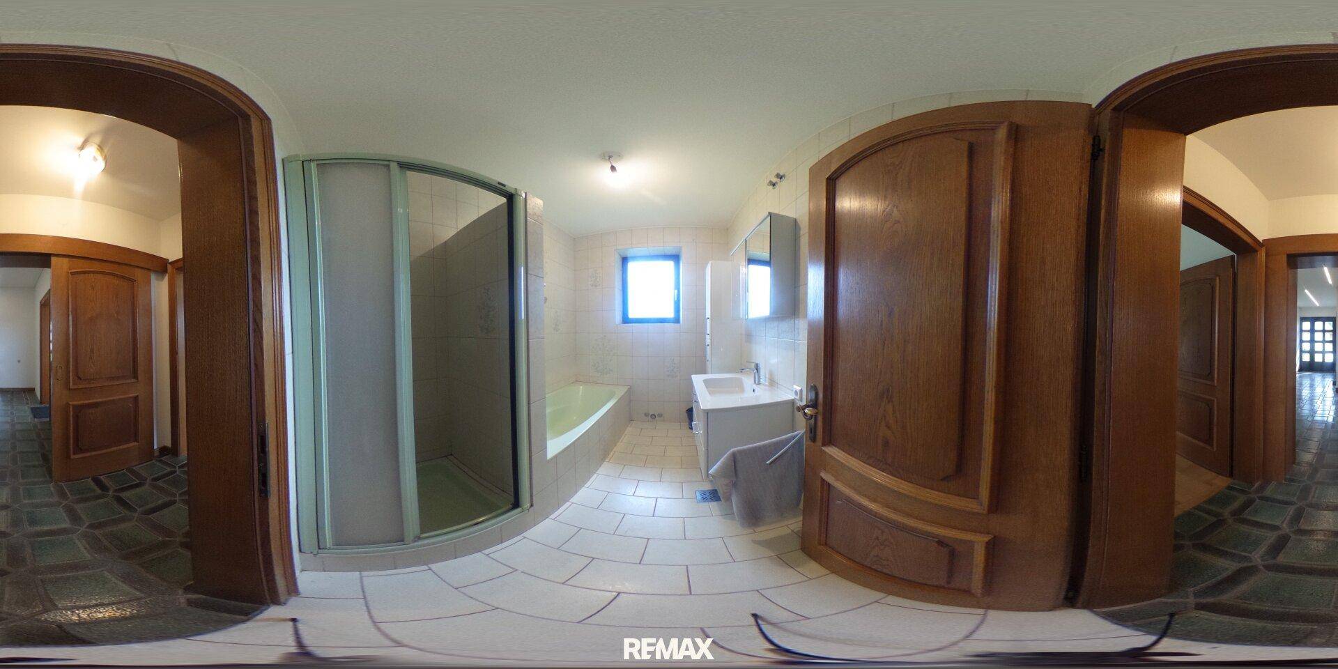Helles Badezimmer mit Duschkabine, Badewanne, Waschbecken und einem kleinen Fenster, gefliest.