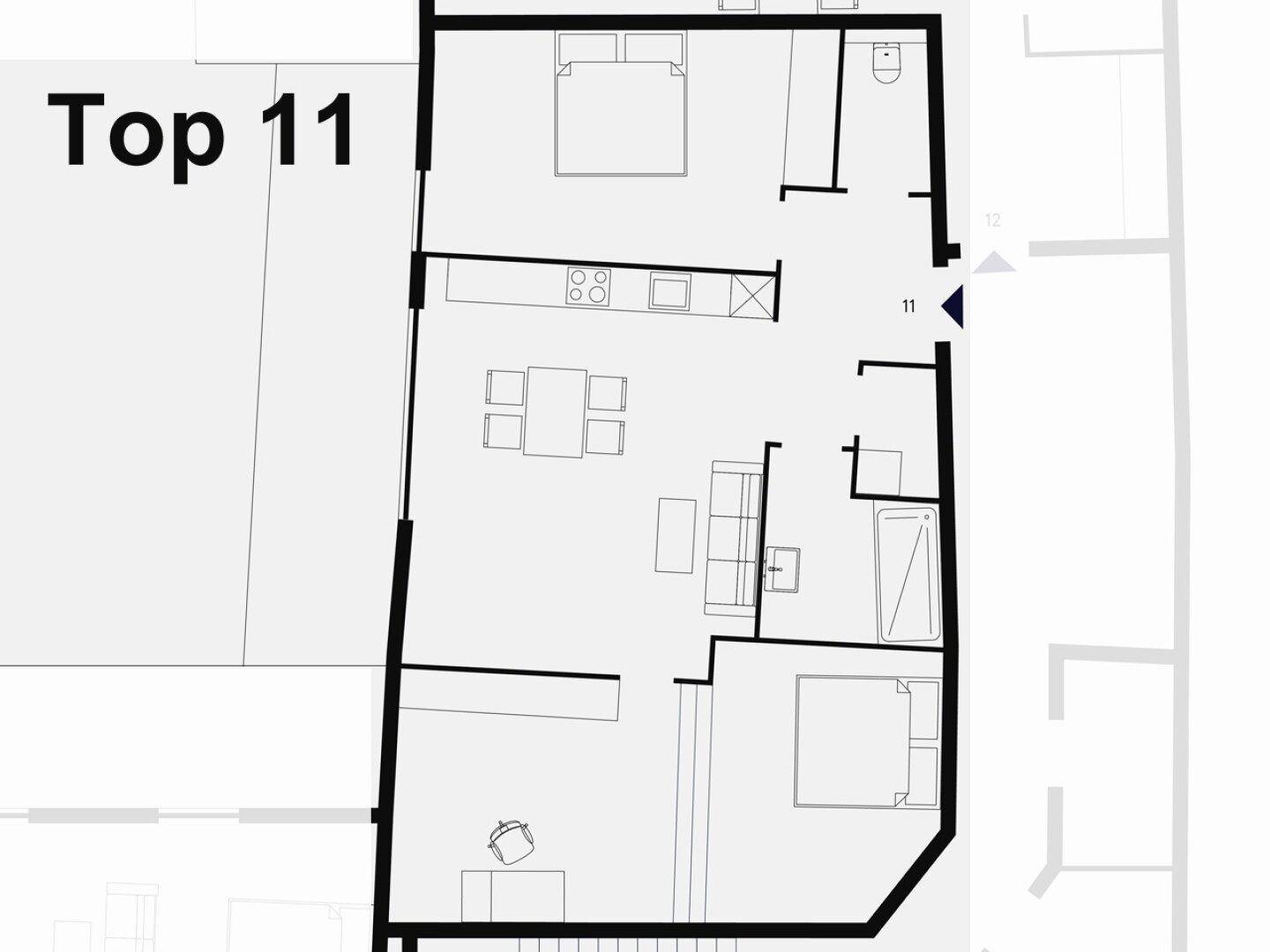 Grundriss der Wohnung Top 11 mit zwei Schlafzimmern und offenem Wohn-Essbereich.