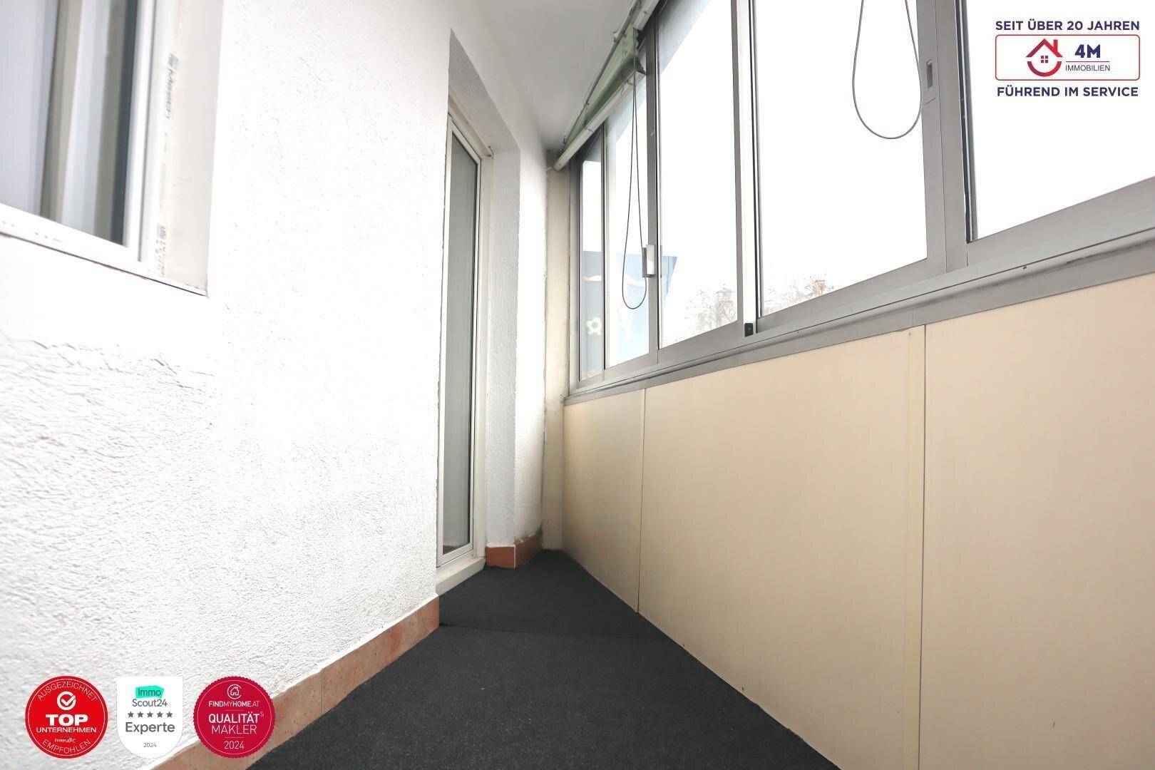 Verglaste Loggia mit Blick nach draußen, ideal für entspannte Stunden.
