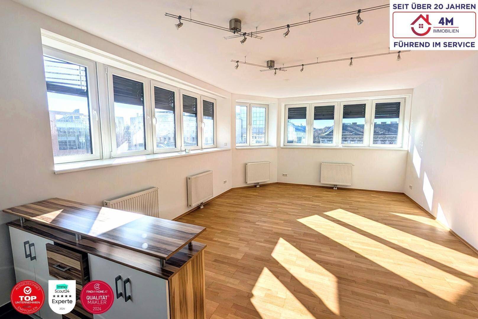 Geräumiges Zimmer mit Parkettboden, großen Fenstern und teilweiser Beschattung durch Jalousien.