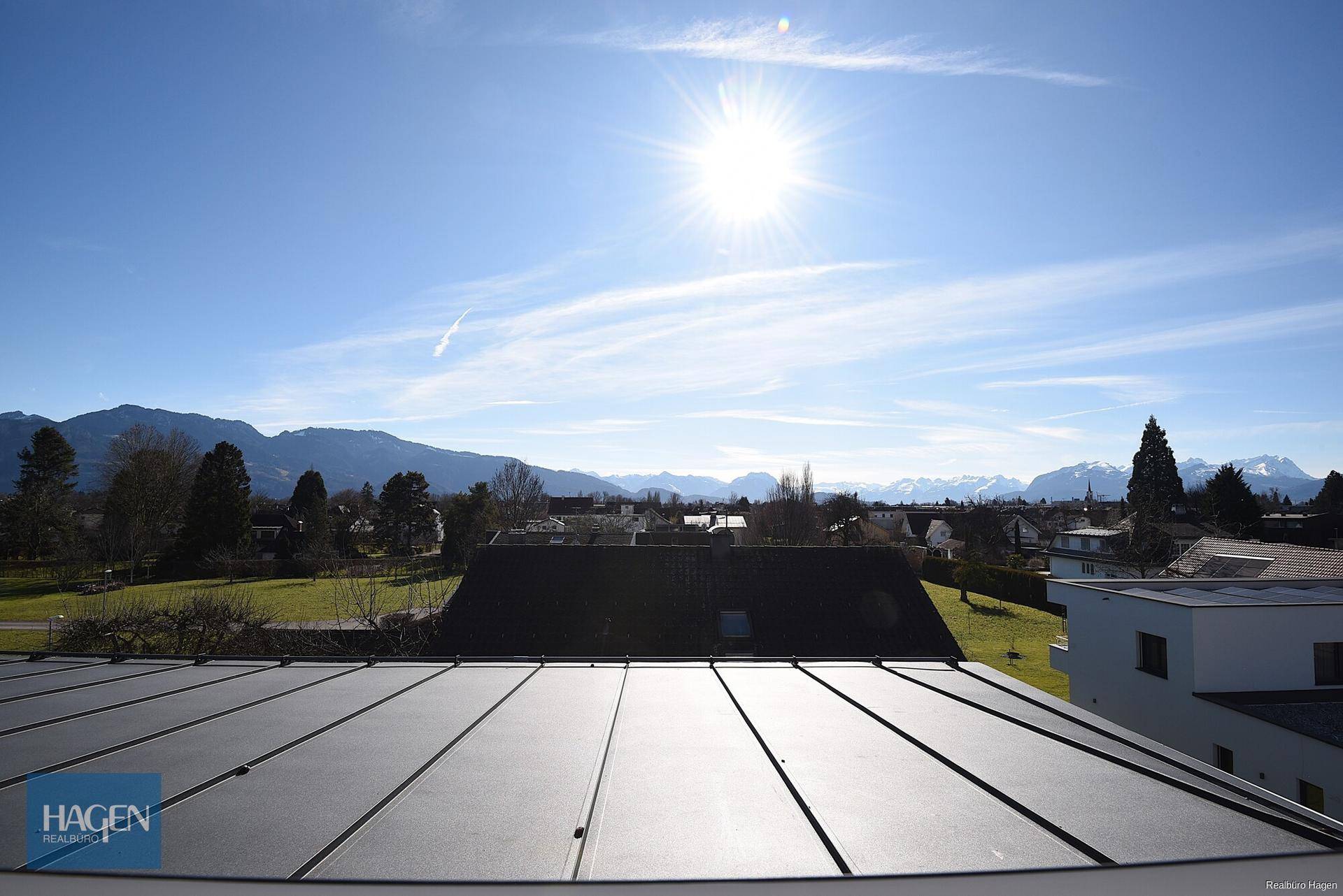 Panoramablick auf die umliegende Berglandschaft und die Dächer der Nachbarschaft.