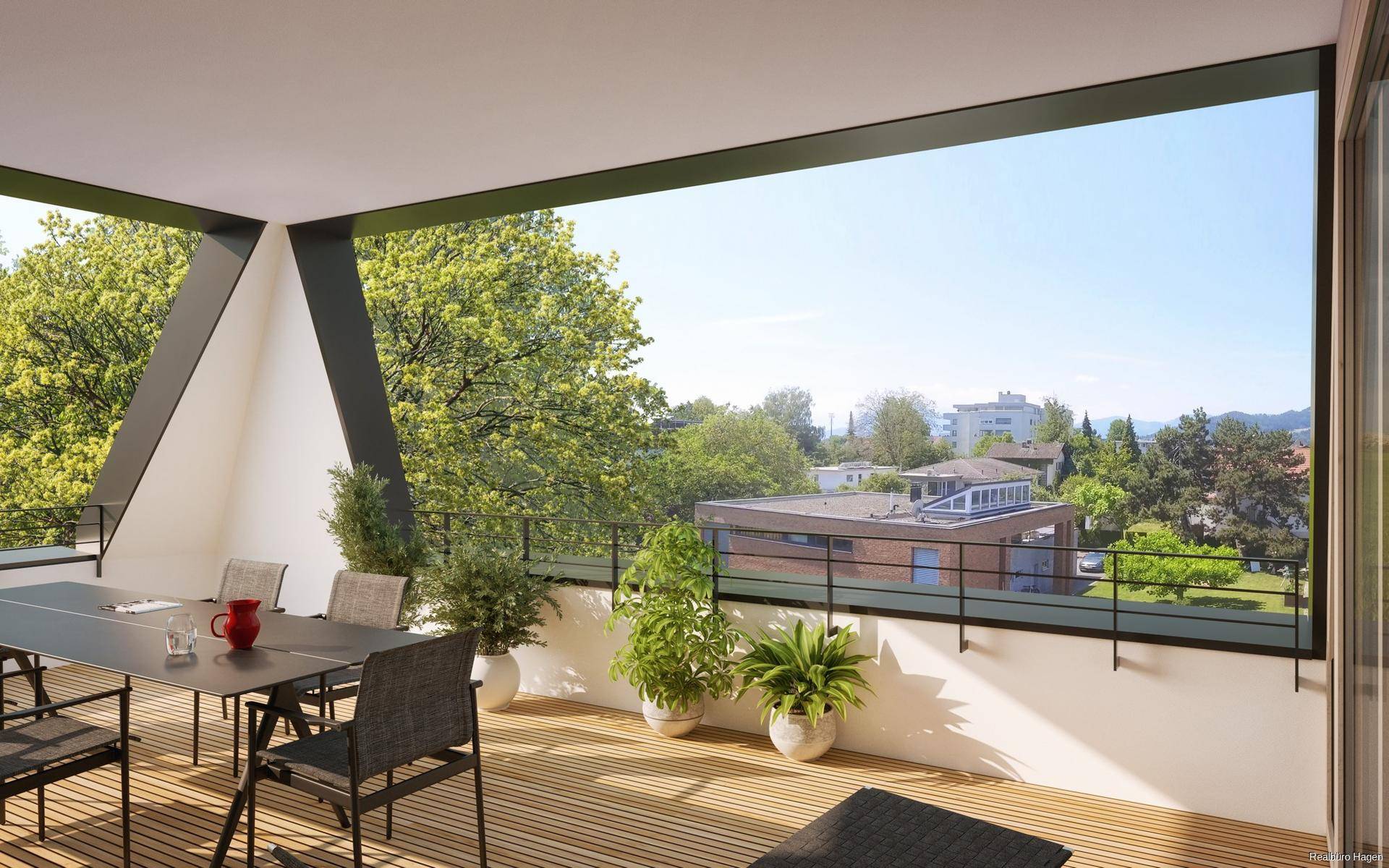 Großzügige Dachterrasse mit Holzboden, Esstisch und weitem Blick ins Grüne.