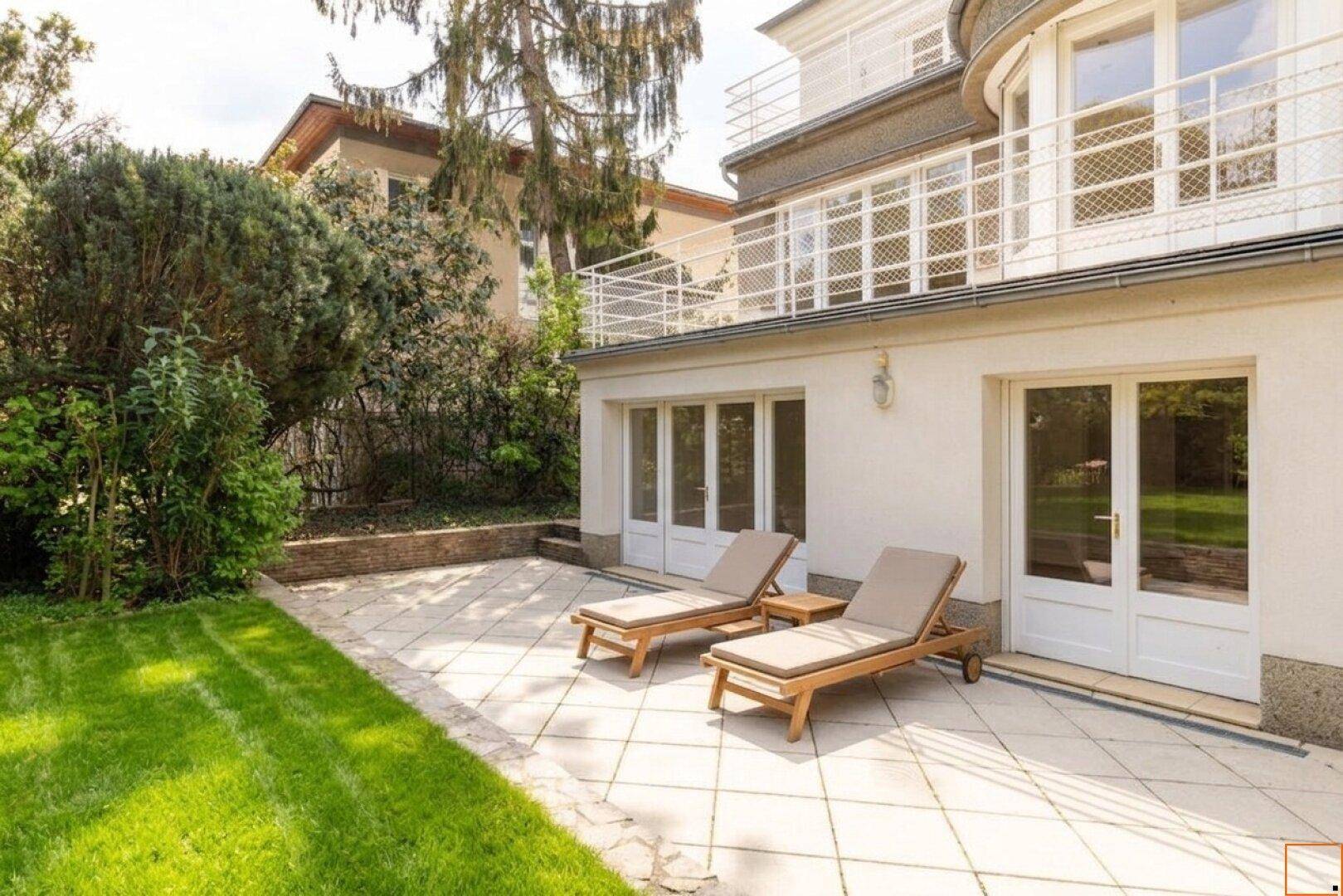 Sonniger Terrassenbereich mit Liegestühlen und direktem Zugang zum grünen Garten.