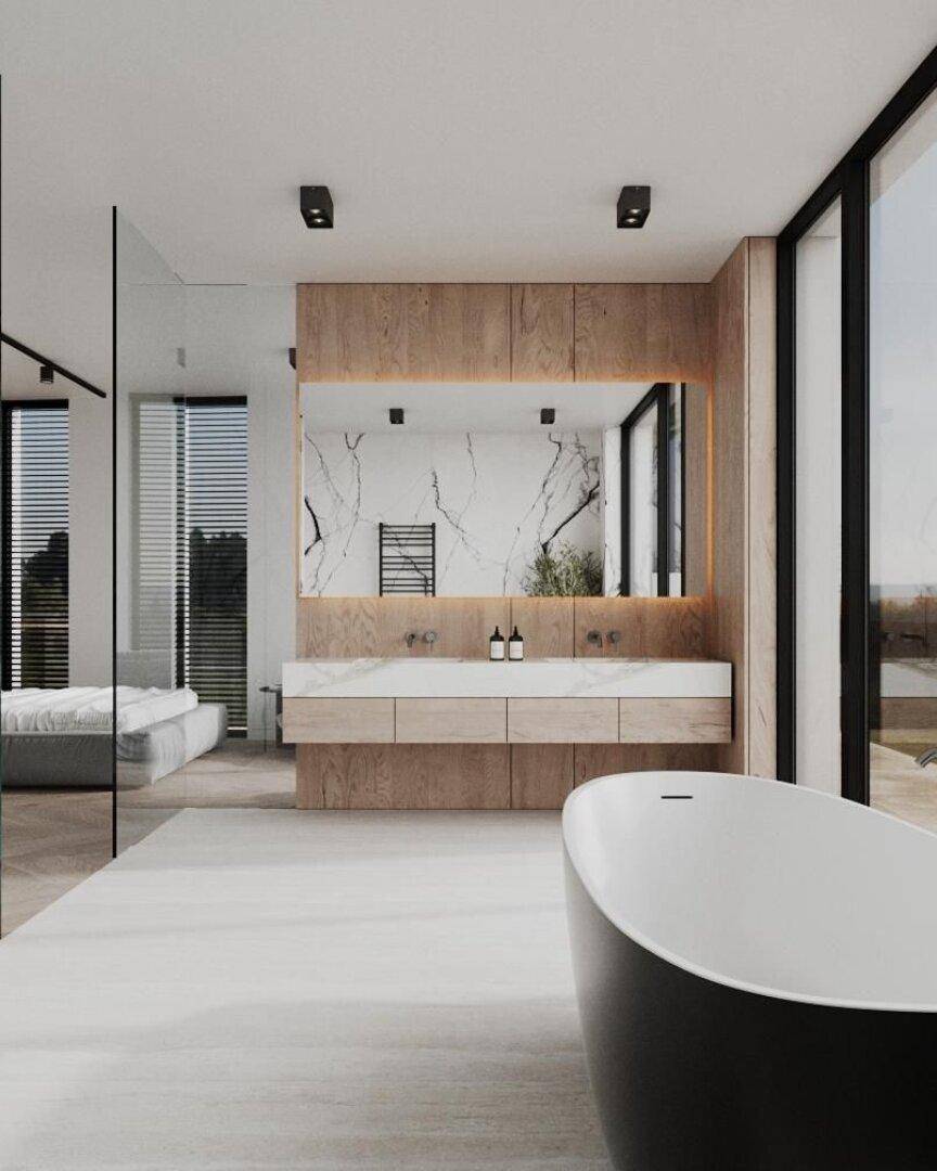Luxuriöses Badezimmer mit Doppelwaschbecken, freistehender Badewanne und Zugang zum Schlafzimmer.