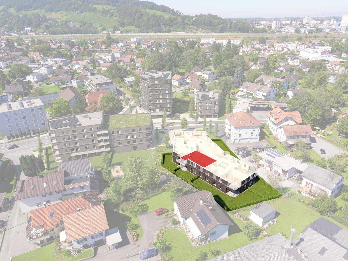 Luftaufnahme des Neubaus in einer Wohngegend mit viel Grün und umliegenden Hügeln.